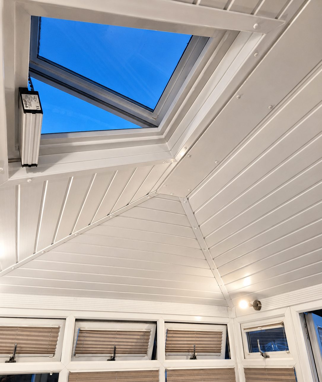 Finished insulated conservatory ceiling with the existing opening roof vent retained