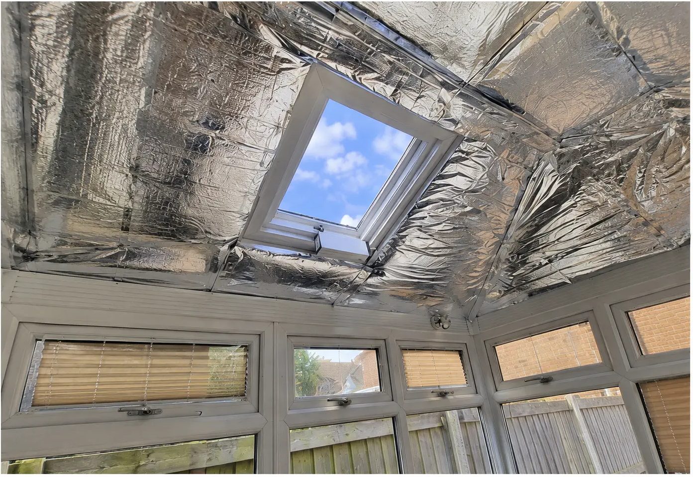 Multi-layered foil insulation fitted to a conservatory ceiling around the existing roof vent in Luton