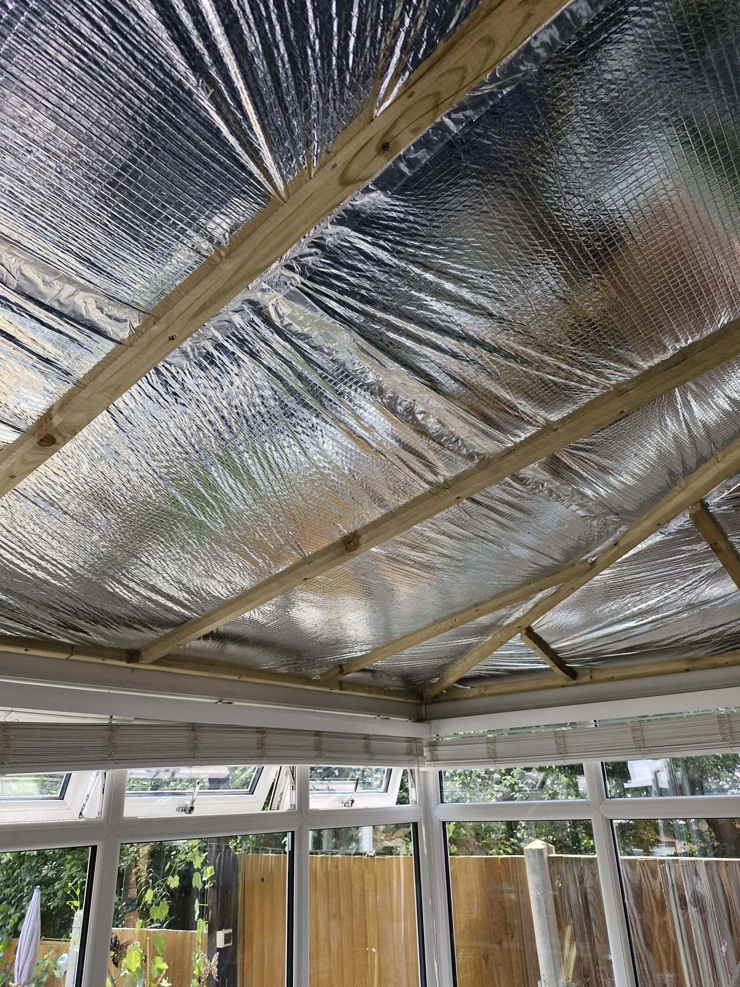 SnugRoof multifoil insulation being installed across roof